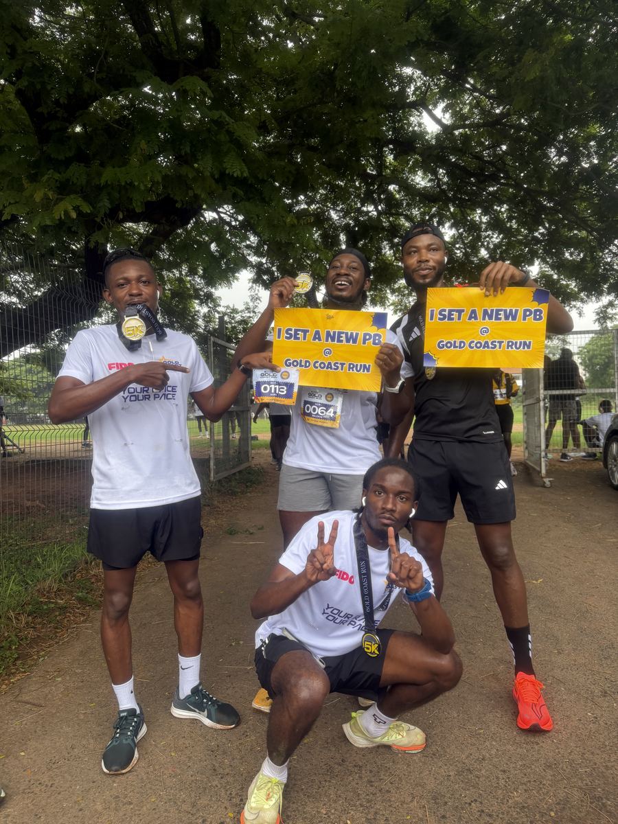 Four runners holding signs reading I set a new PB